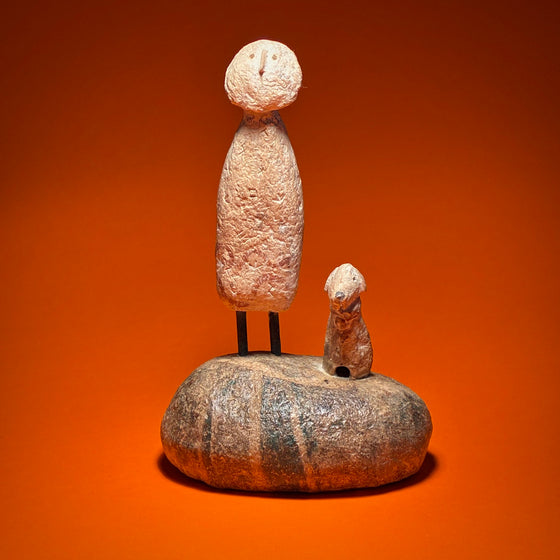 Figure with Dog on Boulder